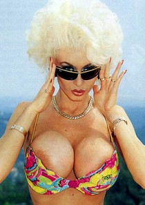 Blonde bombshell Dolly Buster deep cleavage and areola slip